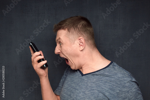 Portrait of furious man arguing with somebody via phone