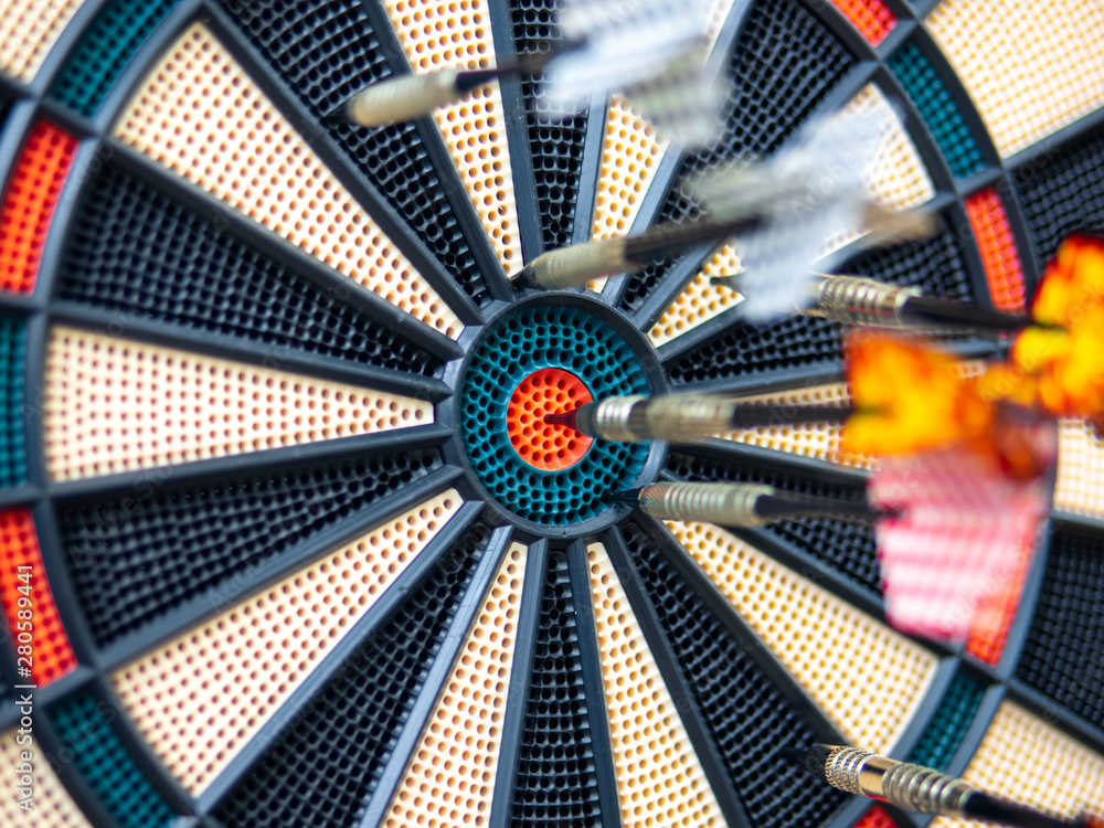Picture of Darts arrow hitting in the target center of dartboard. concept  business goal to marketing success. Business target or goal success and  winner concept. success and risk management. Stock Photo