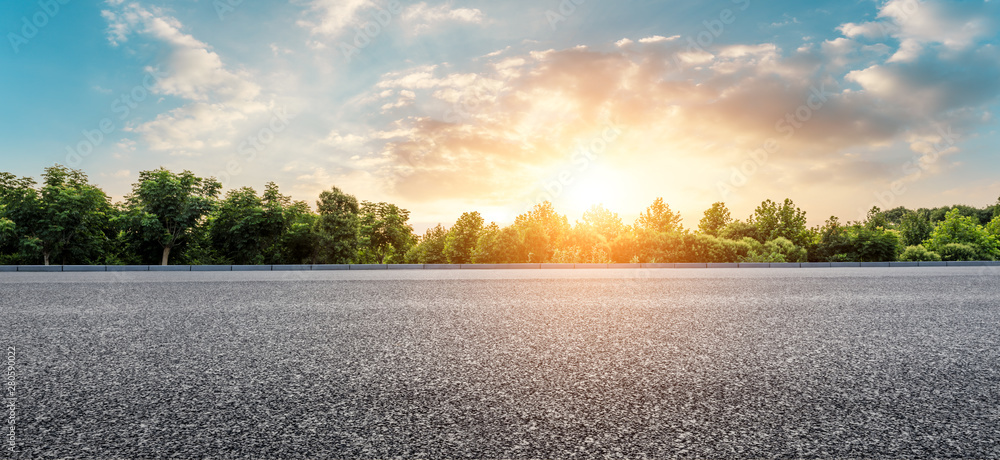 Asphalt highway and green forest with beautiful cloud landscape at sunset Asphalt highway and green forest with beautiful cloud landscape at sunset