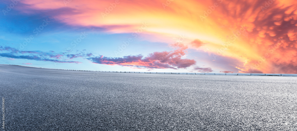 Asphalt highway and beautiful clouds landscape at sunset