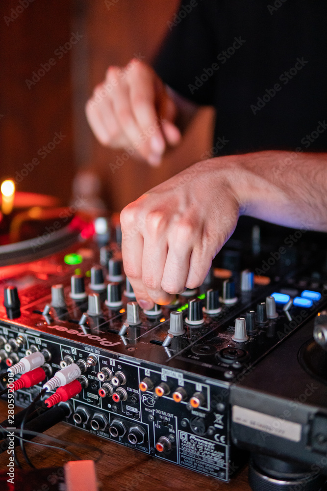 DJ playing on wooden booth at party DJ playing on wooden booth at party