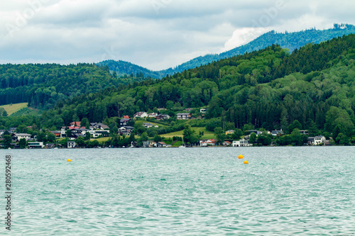 Calm cloudy day on lakefront of Attersee with mountains in background in late summer. lake Attersee in the Austrian Salzkammergut