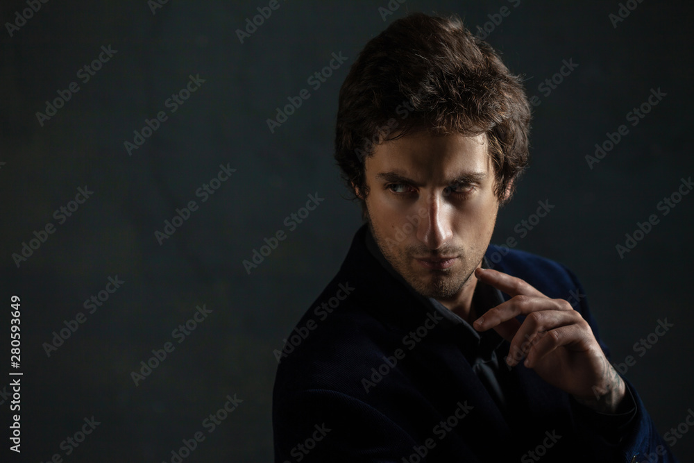 Young thoughtful handsome man with a light stubble on his face.