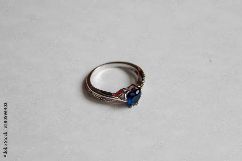 silver ring with blue heart on white background silver ring with blue heart on white background