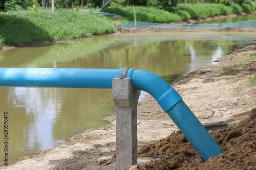 Blue water pipe with support concrete. Water pipeline for agriculture.