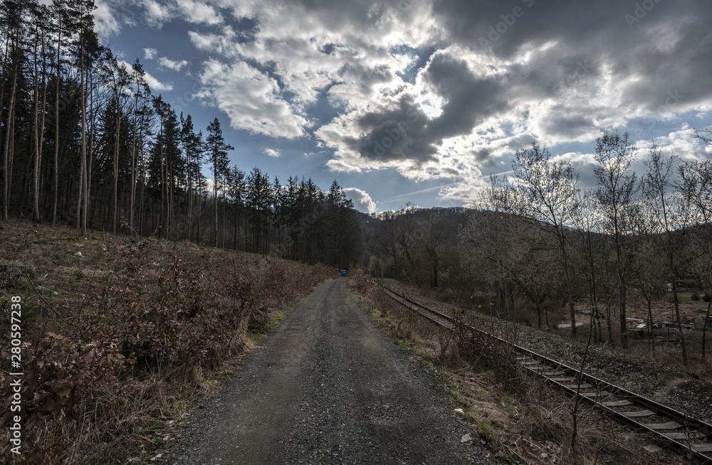 train tracks next to forest path in Sazava river valley in autumn