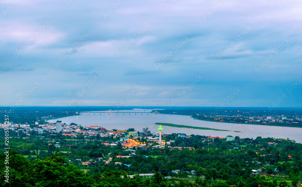 Fototapeta premium Aerial view of Mukdahan with Ho Kaeo Mukdahan and Savannakhet Province, the region with the Mekong River in the middle