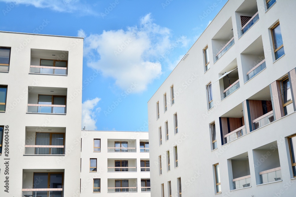 Fototapeta premium modern apartment building with blue sky and clouds