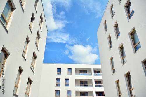 modern apartment building with blue sky and clouds