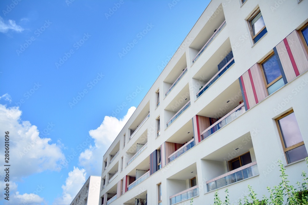 modern apartment building with blue sky and clouds