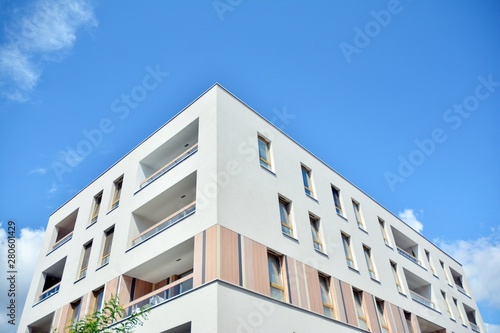 modern apartment building with blue sky and clouds