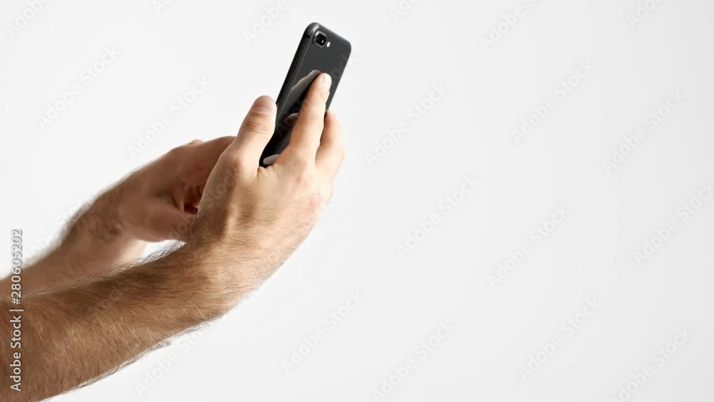 Cropped view of man taking selfie while using smartphone over white background isolated Cropped view of man taking selfie while using smartphone over white background isolated