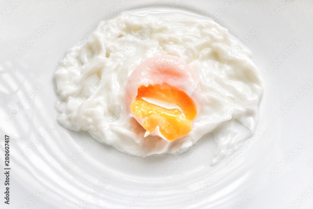 Top view fried egg in a white plate on kitchen table Top view fried egg in a white plate on kitchen table