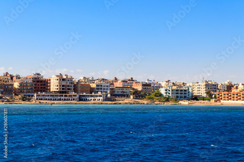 Fototapeta Naklejka Na Ścianę i Meble -  Beautiful view of the coastline with houses and hotels in Hurghada, Egypt. View from Red sea