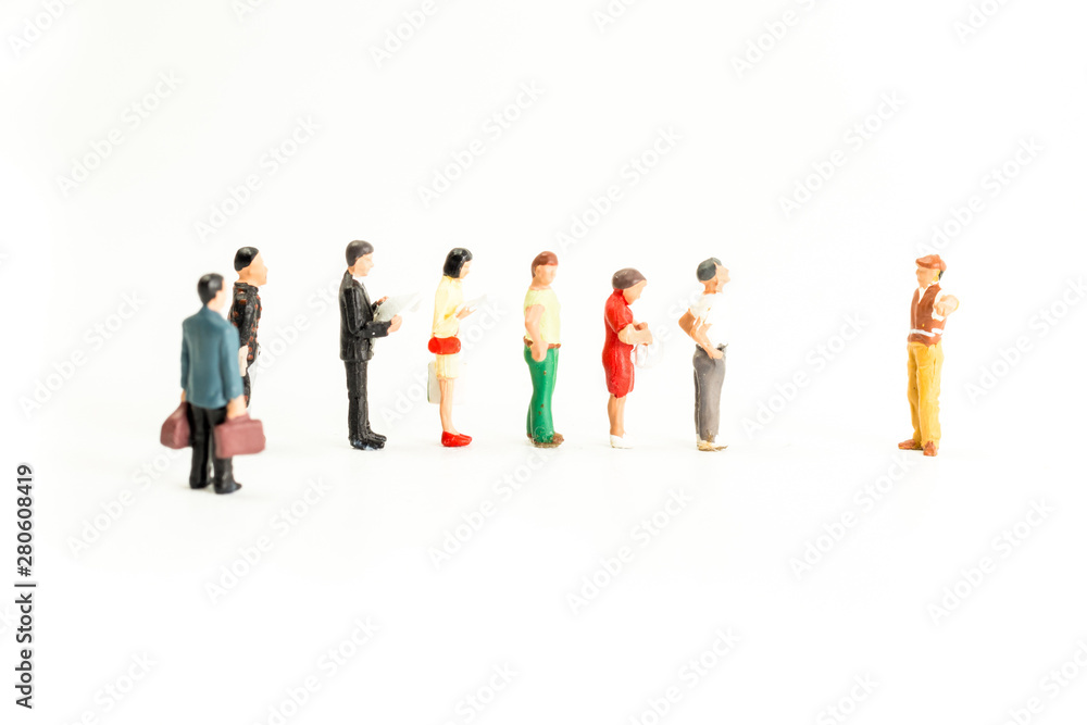 Miniature People Standing in a Line, Waiting Miniature People Standing in a Line, Waiting