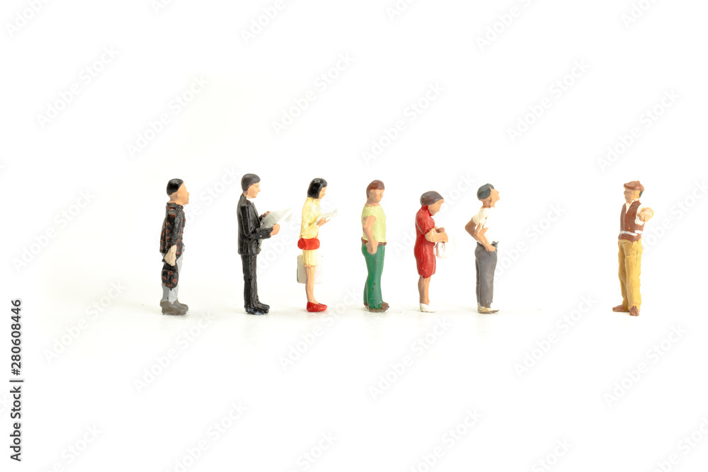Miniature People Standing in a Line, Waiting Miniature People Standing in a Line, Waiting