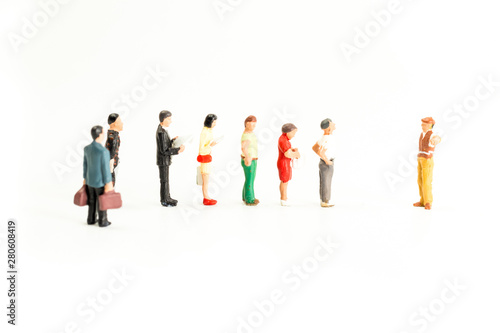 Miniature People Standing in a Line, Waiting