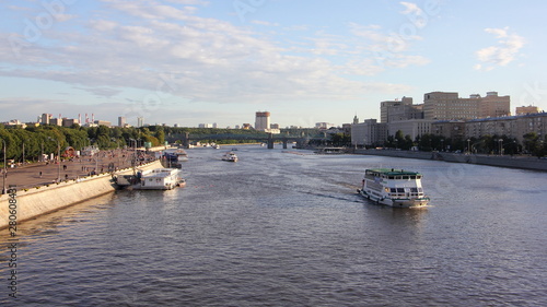 Top view of Pushkin embankment, St. Andrew's bridge in Gorky Park and the Moscow river with ships on a Sunny summer day against the blue sky
