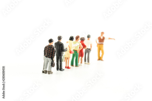 Miniature People Standing in a Line  Waiting