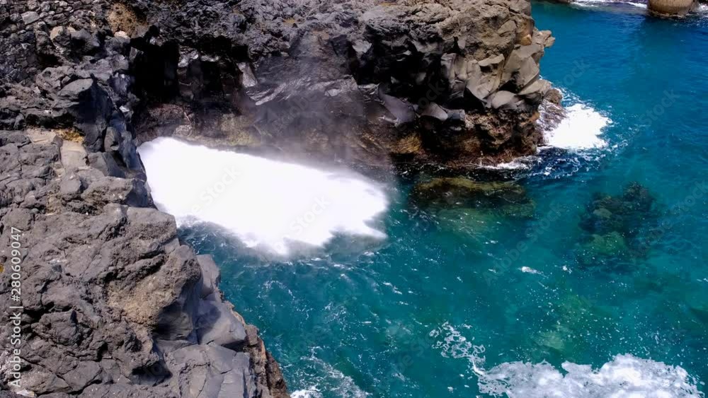Waves hitting the northern coast of Madeira island in the middle of the Atlantic Ocean with a horizontal blowhole. Slow motion clip at half speed. Waves hitting the northern coast of Madeira island in the middle of the Atlantic Ocean with a horizontal blowhole. Slow motion clip at half speed.