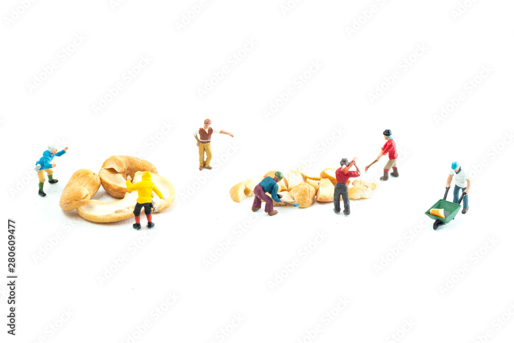 Obraz premium People Working with Food, Miniature people harvesting nuts/cashews, construction site