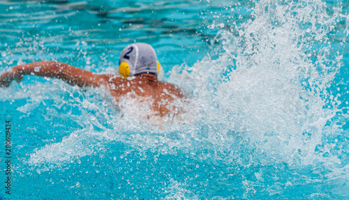 Athletes swimming freestyle on a swimming pool