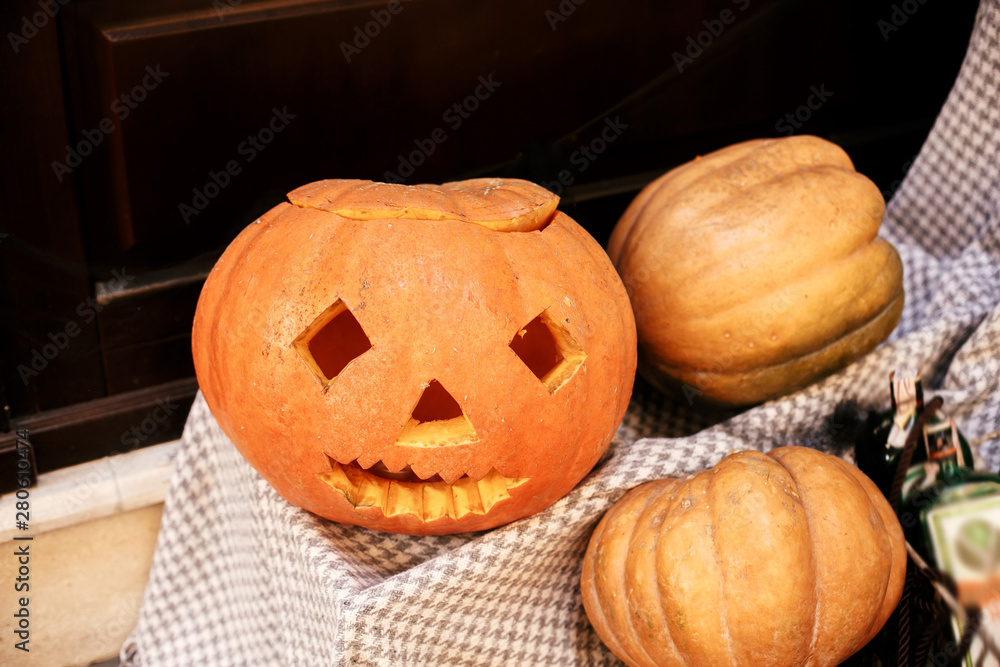 Halloween street decor. Jack o lantern pumpkins on city street, holiday decor of store fronts and buildings. Autumn market in town. Space for text. Trick or treat. Happy halloween Halloween street decor. Jack o lantern pumpkins on city street, holiday decor of store fronts and buildings. Autumn market in town. Space for text. Trick or treat. Happy halloween