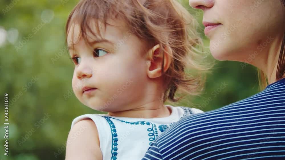 Mother and her baby daughter exploring the outdoors. 4K real life, candid footage. Mother and her baby daughter exploring the outdoors. 4K real life, candid footage.