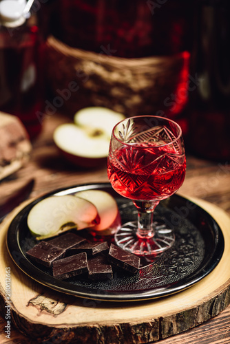 Homemade red currant nalivka and chocolate with apple