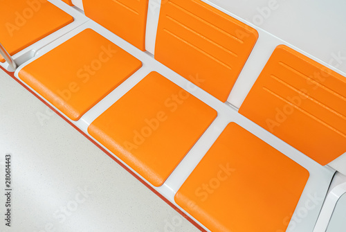 Orange chairs on white back...