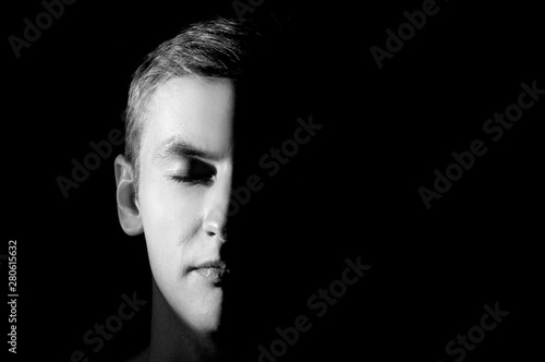 black and white photo, large portrait half face lit photo