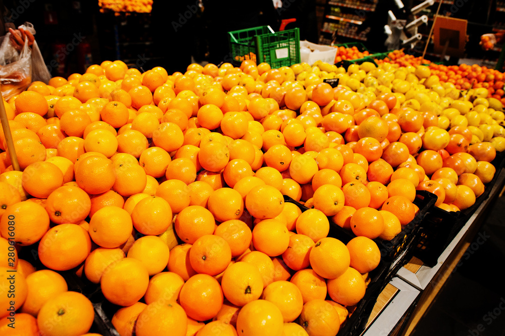 Yellow oranges on boxes at supermarket.