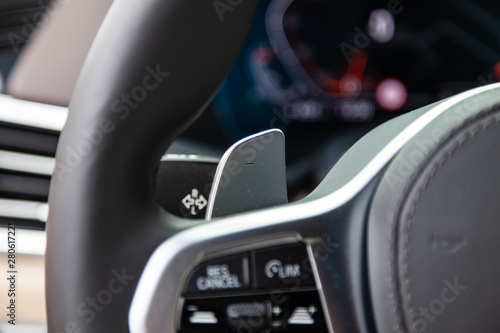 View to the white and brown interior of car with steering wheel and shiftgear paddle after cleaning before sale on parking photo