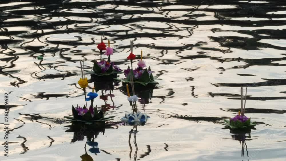Paper lotus flower with candle floating on a river at night in Loy krathong festival, traditional Siamese new year festival celebrated in Thailand. Paper lotus flower with candle floating on a river at night in Loy krathong festival, traditional Siamese new year festival celebrated in Thailand.