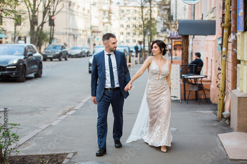 Wedding portrait of a young couple on a city street