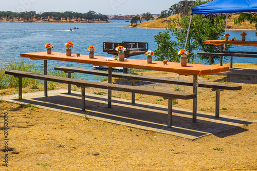 Picnic Tables By Side Of Lake