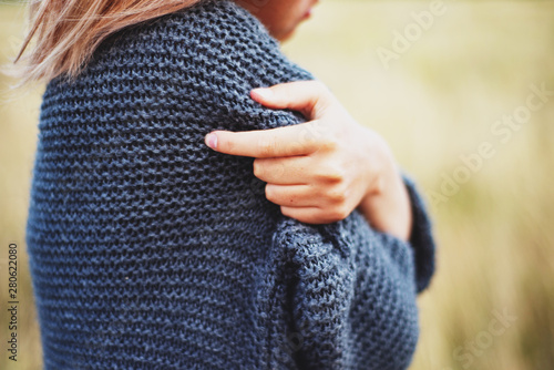  girl in a warm gray sweater in the field