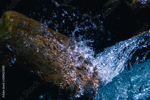 Blue Water Falling on A Rock