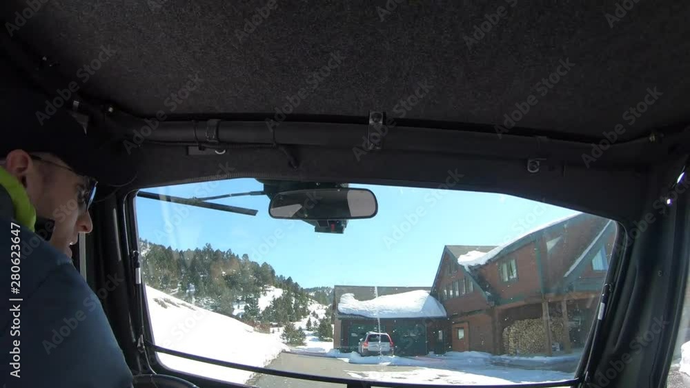 Time lapse of a man in a UTV driving to a large home in winter. Time lapse of a man in a UTV driving to a large home in winter.