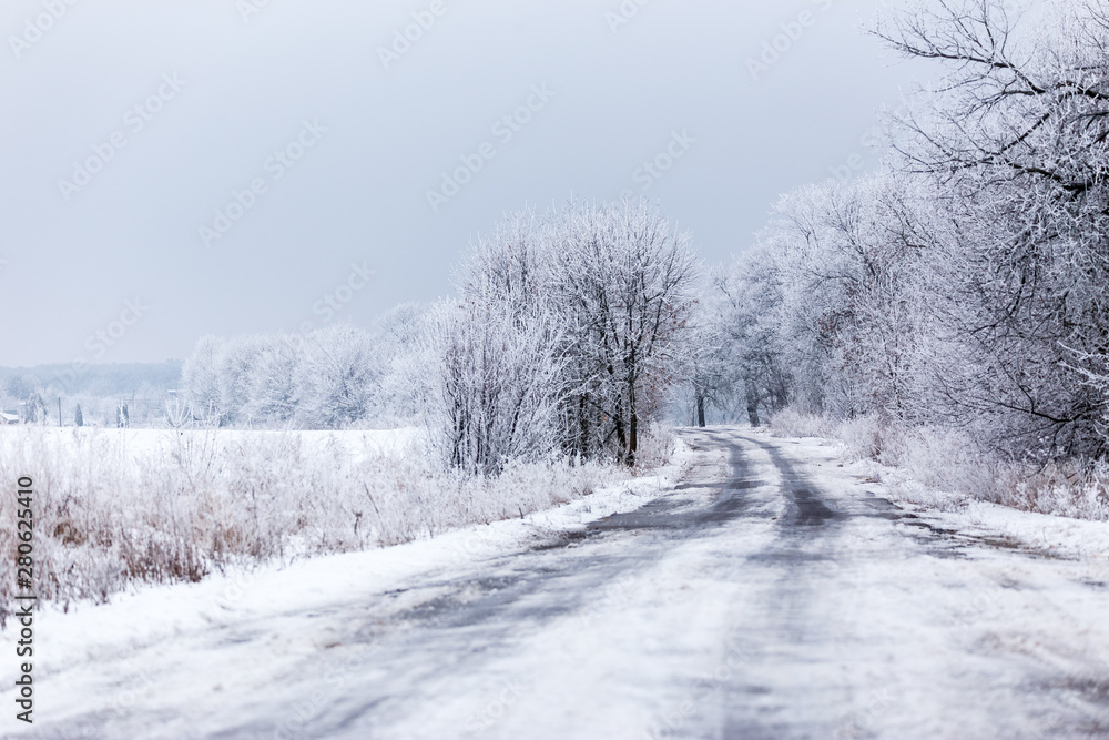 Winter rural road landscape with frozen asphalt path. Winter rural road landscape with frozen asphalt path.