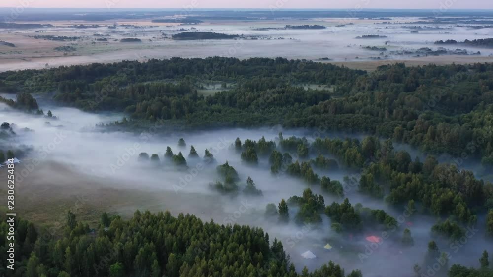 Flying over the forest, river and golden layers of morning fog Flying over the forest, river and golden layers of morning fog