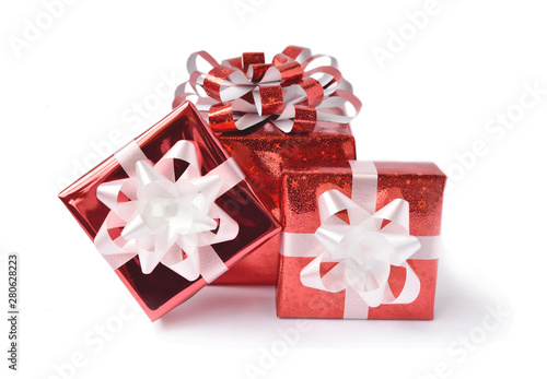 Red gift box and ribbon bow on white background. Concept for Valentine day, Christmas present and New Year. photo