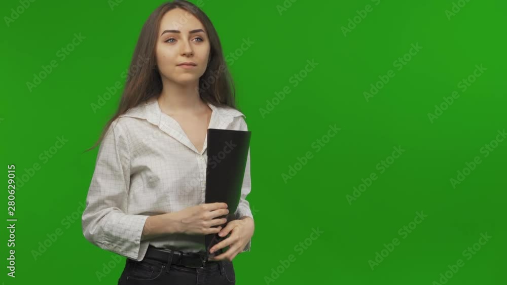 Smiling young woman student enter in the frame. She`s looking for something. Looking for a job. In search of something. Green Screen, Chroma Key. Smiling young woman student enter in the frame. She`s looking for something. Looking for a job. In search of something. Green Screen, Chroma Key.