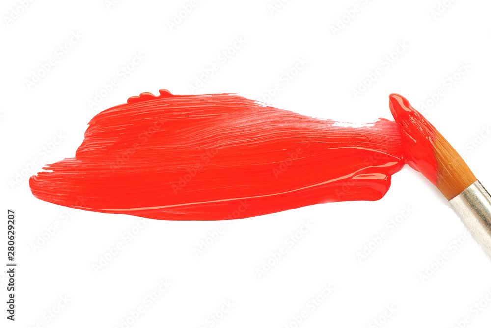 a brush in red paint and a smeared spot of orange acrylic paint on a white blank sheet of paper.. a brush in red paint and a smeared spot of orange acrylic paint on a white blank sheet of paper..