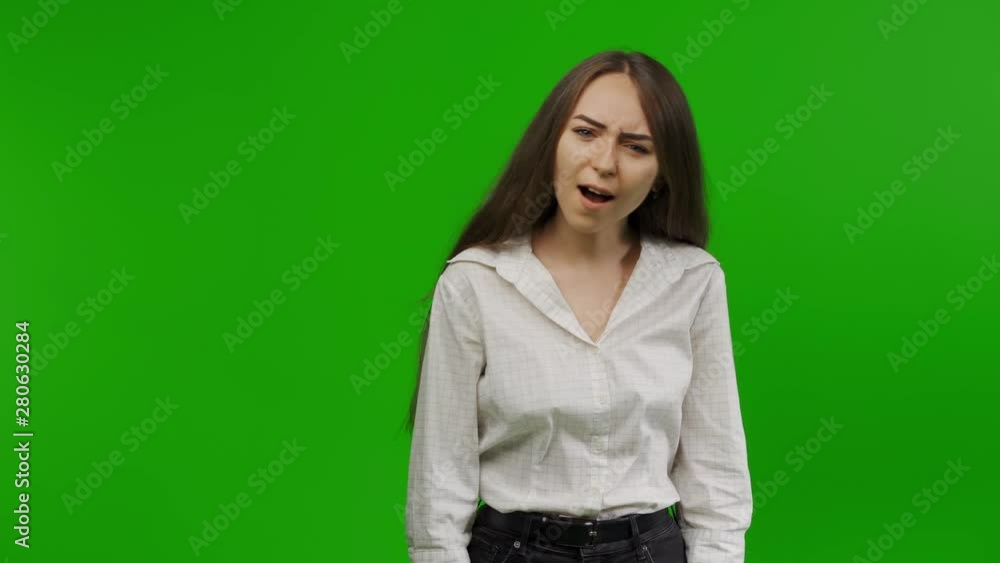 Astonished woman looks into the camera and can not believe it. She is outraged and serious. How could this happen? Green Screen, Chroma Key. Astonished woman looks into the camera and can not believe it. She is outraged and serious. How could this happen? Green Screen, Chroma Key.
