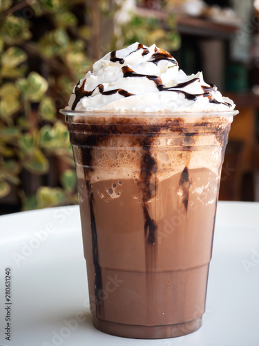 Mocha frappe in plastic cup. Served with whipping cream and chocolate sauce. Freshness drink. Favorite caffeine beverage menu.