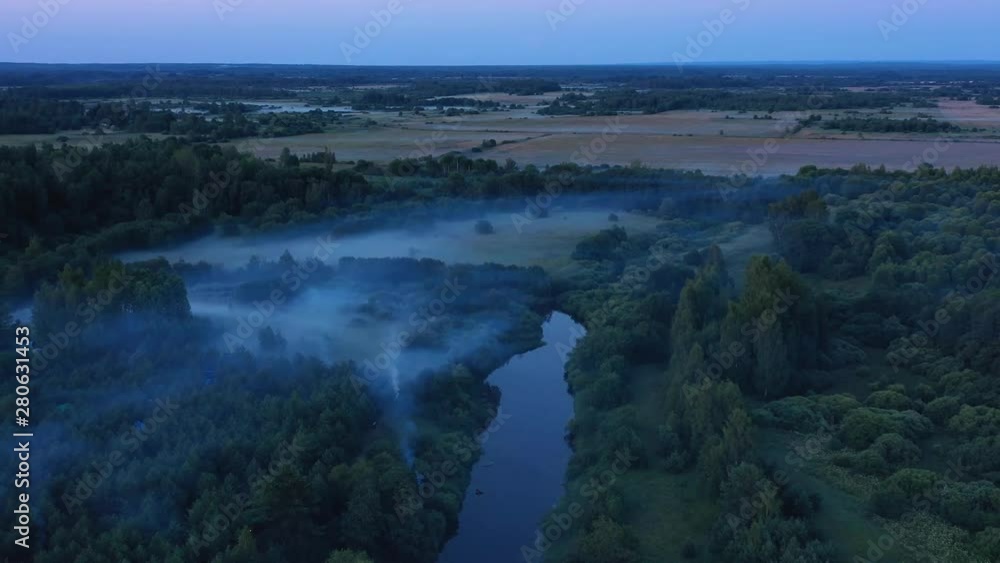 Flying over the forest, river and golden layers of morning fog Flying over the forest, river and golden layers of morning fog