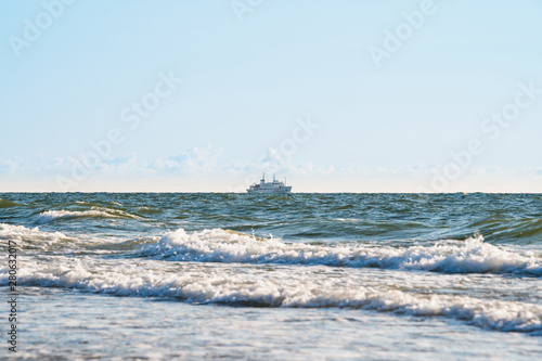the ship sails on rough seas near the shore © Dmitriy Popov