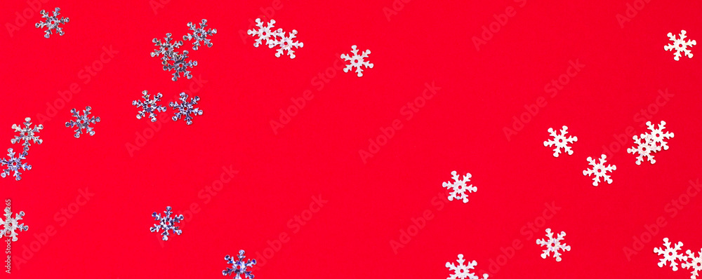 top view snowflake confetti mess on a red background,abstract festive winter background top view snowflake confetti mess on a red background,abstract festive winter background
