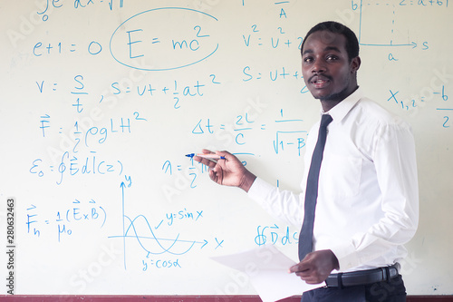 African foreign teacher teaching science in the classroom.